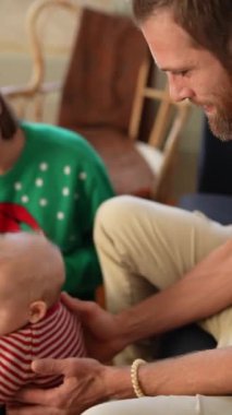 Sevgi, mutluluk ve güzel bayram ruhuyla dolu bir bebeği gösteren neşeli bir aile etkileşimi.