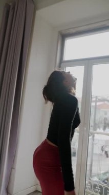 Bir insan, pencereden süzülen doğal ışıkla hafifçe aydınlatılan sıcak bir alana derin bir yansıma yapar.