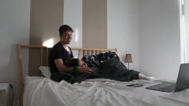 Sevgi dolu bir adam, çok şık bir yatak odası ortamında bir çocukla şefkatli ve yürek ısıtan bir anı paylaşır.