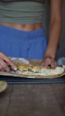 Yetenekli eller lezzetli ev yapımı pastaları ustalıkla kesiyor, etkileyici mutfak becerileri sergiliyor.