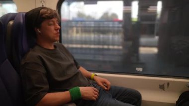 Genç bir seyyah, bugün trende giderken gezici cihazının keyfini çıkarıyor ve modern yolculuğun gerçek özünü yakalıyor.