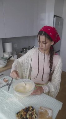 Bir kadın zevkle yemek pişirir ve muhteşem mutfak yeteneklerini şık ve modern bir mutfakta gururla sergiler.