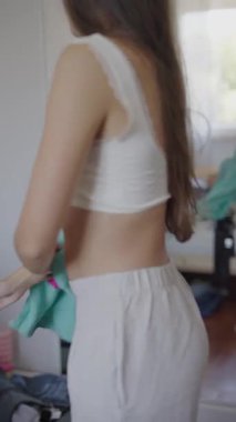 Rahat ve rahat bir ev ortamında şık giysiler içinde bir model geçişi.