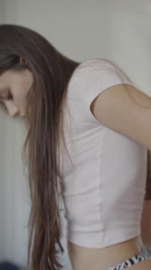 Model, şık ve modaya uygun bir kıyafet sergiliyor. Güzel, beyaz bir etek ve üstüne oturan bir bluz içeriyor.