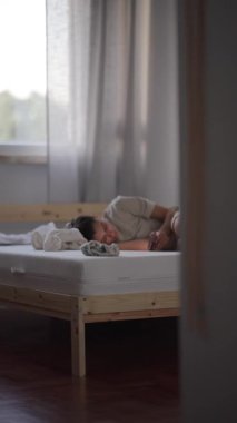 Bir çocuğun huzurlu ve güzel anı. Parlak, minimalist bir odada huzur içinde uyuyor. Işıkla dolu.