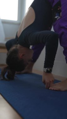 Bir uzman, olağanüstü esneklik ve dengeyi vurgulayan zorlu ve karmaşık bir yoga duruşu sergiliyor.
