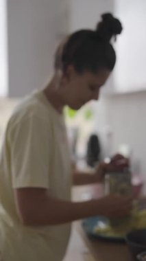 Mutfak ortamında patates rendeleyen, yemek hazırlama ve mutfak yaratıcılığı sergileyen biri..