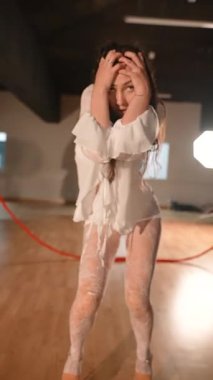 Bir stüdyo ortamında dinamik hareketler ve derin duygular sergileyen etkileyici bir dans gösterisi.