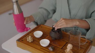 Huzurlu bir çay hazırlama sahnesi. Güzel bir çaydanlık, zarif bardaklar ve güzel bir tepside aksesuarlar.
