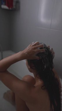 Bir kadın, çağdaş bir ortamda son derece rahatlatıcı ve ferahlatıcı bir saç yıkamadan zevk alır.