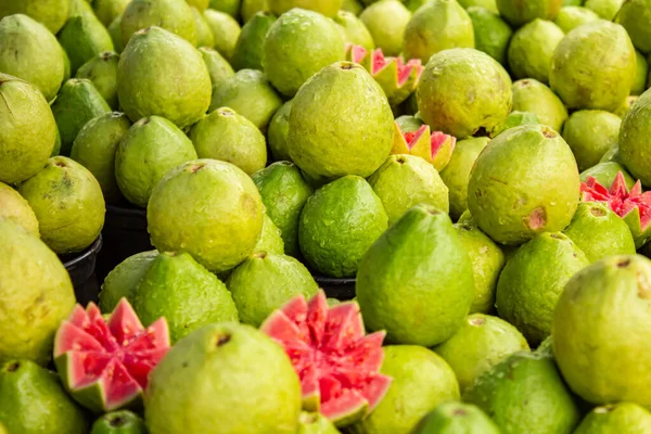 stock image Various guavas on display with some cut and arranged to be sold at a fair.