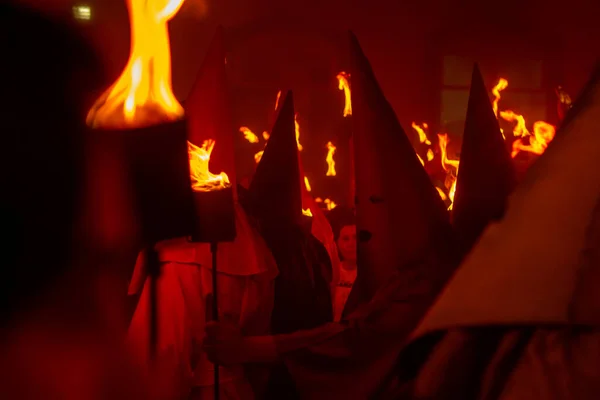 stock image Several farricocos with fire torches during the Fogareu Procession, a religious festival that takes place every year in the city of Goias, on the eve of Easter.