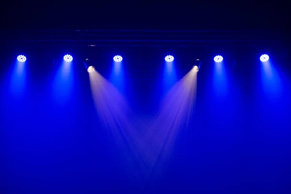 Set of stage lights in a theater. Lighting equipment with lights in blue and white colors.