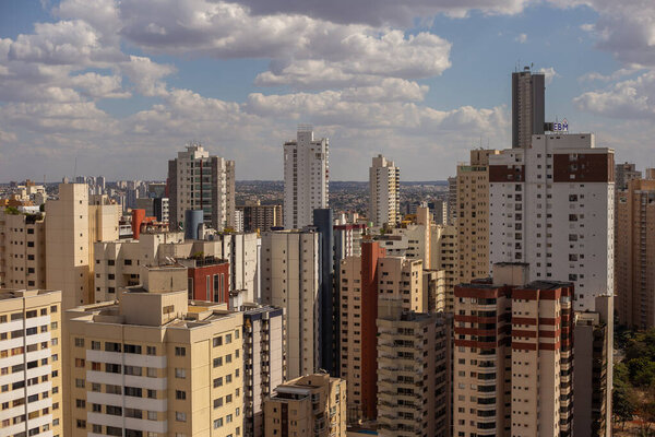 A panoramic view of the city of Goiania with several buildings on a clear day with some clouds in the sky.