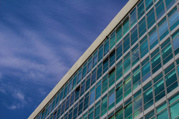 A detail of the architecture of one of the Ministries in Braslia - DF, with many windows and blue sky in the background.