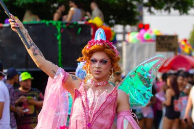 Goiania şehrindeki LGBT Onur Yürüyüşü sırasında sokakta dans eden, pembeli bir trans kadın..