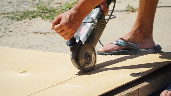 stock image Carpentry works. A carpenter cuts an OSB board with an electric jigsaw. Wood sawing. Construction. n