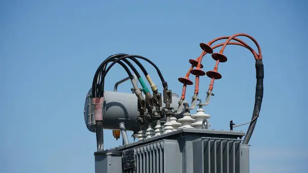 High and low voltage transformer bushings with electrical insulation and electrical equipment at a power substation. electrical equipment at the substation. n
