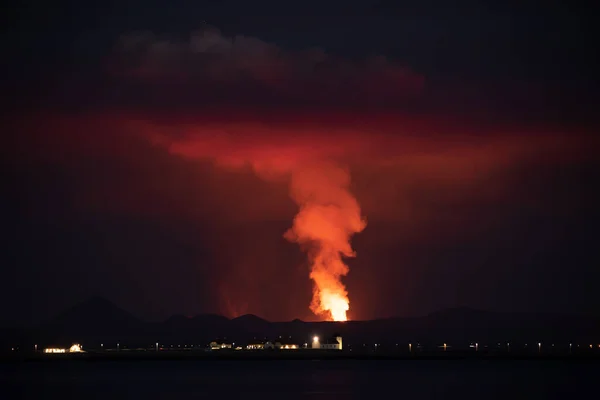 Volcano erupting behind the celandic presidential estate