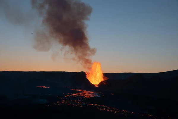 Small plane flying over erupting volcano at dawn, Geldingadal Iceland