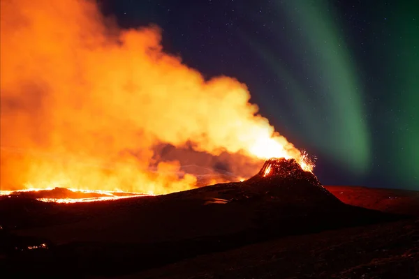 Aurora borealis over volcanic eruption Geldingadal Iceland