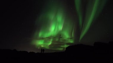 Partners embrace under aurora borealis real-time video