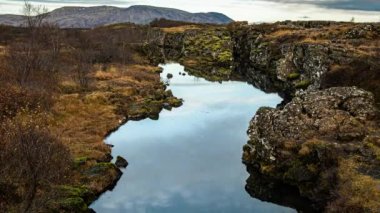 Thingvellir Iceland mirror reflection water filled gorge autumn day