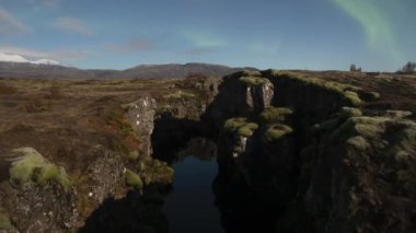 Aurora borealis under full moon in Thingvellir national park Iceland