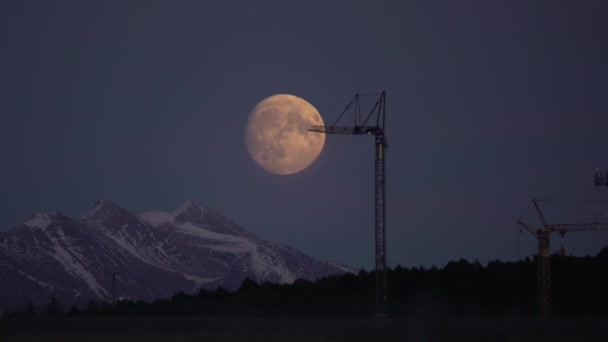 Large Full Moon Rising Construction Crane Reykjavik Iceland Time Lapse — Stock Video