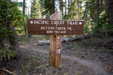 Pacific Crest Trail Sign in Crater Lake National Park points toward Rim Village and Dutton Creek Trail