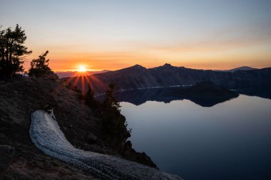 Sunset Rays Over the Mountains Behind Crater Lake from Garfield Peak in summer