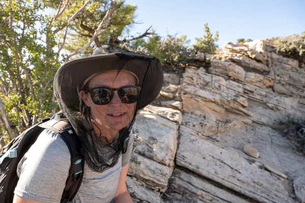 Woman Wearing Bug Net Enjoys Hiking without Flying Pests in Zion National Park
