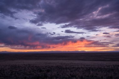 Evening Clouds Glow Pink and Orange Over High Plains of Colorado outside of Great Sand Dunes National Park