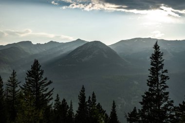 Sunlight Cutting Through Smoke Backlights Mountainside in Rocky Mountain National Park