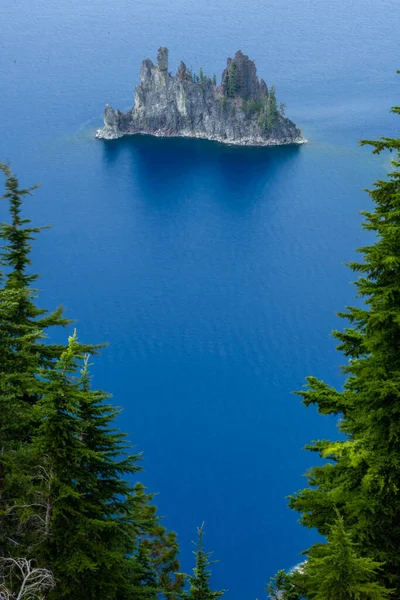 stock image Phantom Ship Island Through the Bright Green Pines In Crater Lake National Park