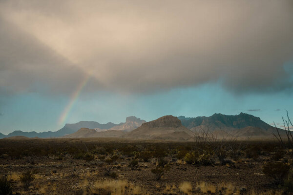 Rainbow Falls from Cloudy Sky Over the Chisos Mountains in Big Bend