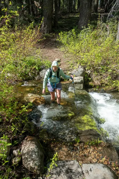 stock image Woman Crosses Rushing Shin Deep Water in Creek in Yosemite