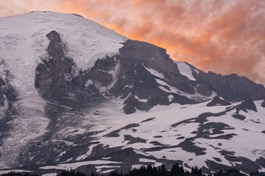 Glaciers Hold Tight To The Top Of Mount Rainier At Sunset in summer clipart