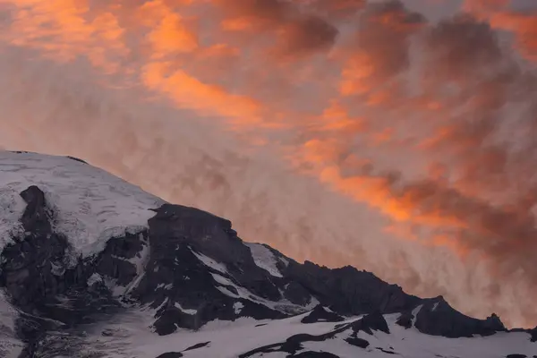 stock image Orange Clouds Fill The Sky Over A Close Up Of Mount Rainier Ridge at Sunset