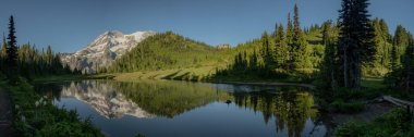 Mount Rainier Reflects In The Calm Waters Of Klapatche Lake along the Wonderland Trail clipart