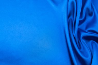 Arkaplan olarak mavi saten veya ipek kumaş