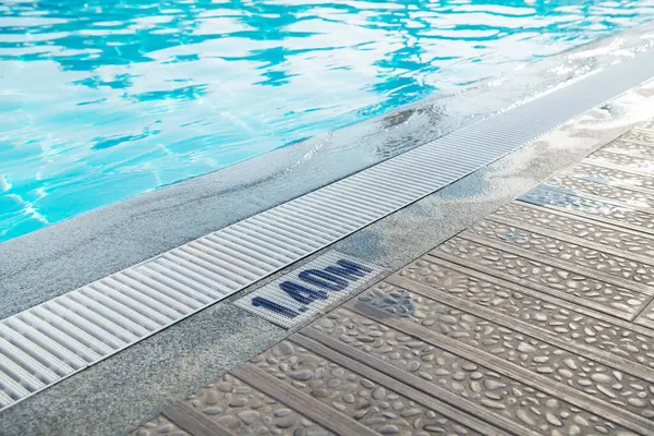 Overflow grating of swimming water pool.