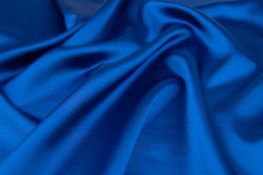 Arkaplan olarak mavi saten veya ipek kumaş
