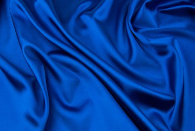 Arkaplan olarak mavi saten veya ipek kumaş