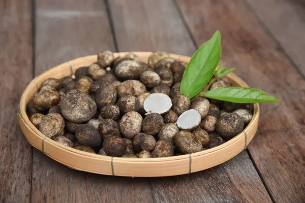 stock image Puff Ball Mushrooms (Hygroscopic earthstar) in a bamboo tray on wooden table backgournd.