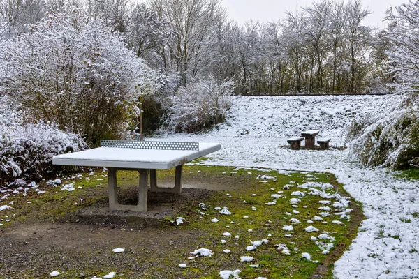 Ping pong table covered with snow outdoors