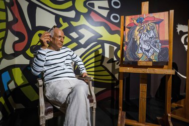 Antalya, Turkey - September 10, 2021: Pablo picasso a spanish painter sitting on a chair in a wax museum clipart