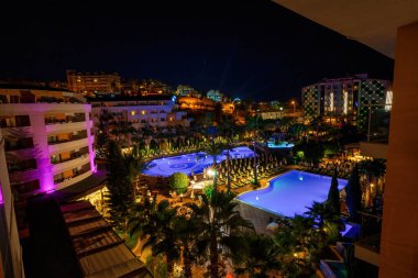 Alanya, Türkiye - 11 Eylül 2021: Geceleri havuzlu bir sahil beldesinde 5 yıldızlı bir mülkün içi