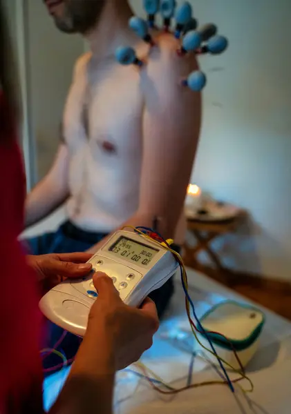 Health Care acupuncture concept, A man is being treated using acupuncture electric stimulation treatment to relax Body Muscle, Machine for Electrode Pads Physiotherapy, reading device