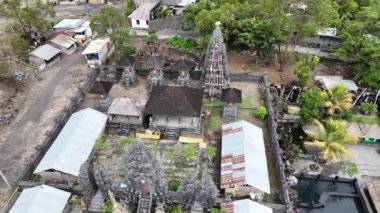 Bali 'deki Batur Sıcak Baharı' nın büyüleyici 4K hava aracı görüntüsünde buharlı havuzlar, Batur Gölü 'nde sürüklenen bir tekne ve tepelerde yuva yapmış antik bir Bali tapınağı olan Kintamani dağ bölgesi yer alıyor..